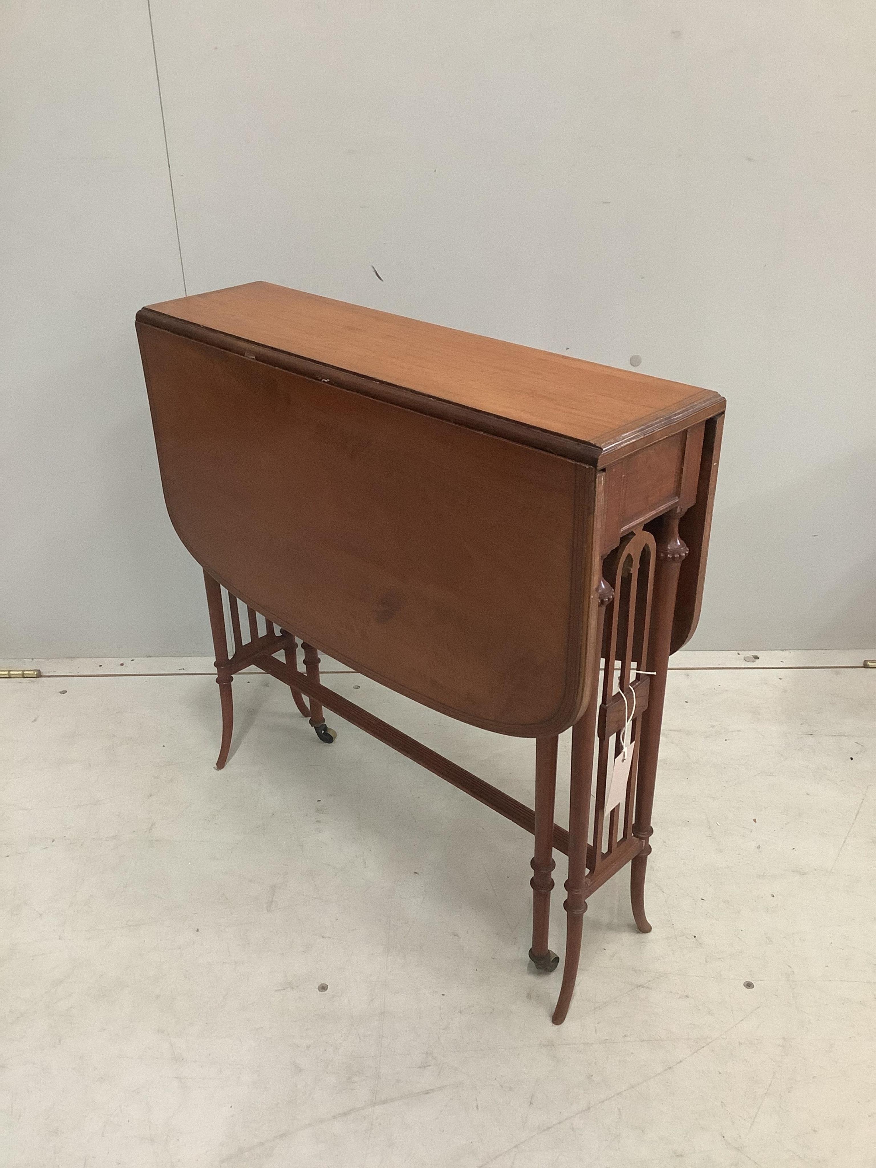 An Edwardian banded satinwood Sutherland table, width 60cm, depth 18cm, height 61cm